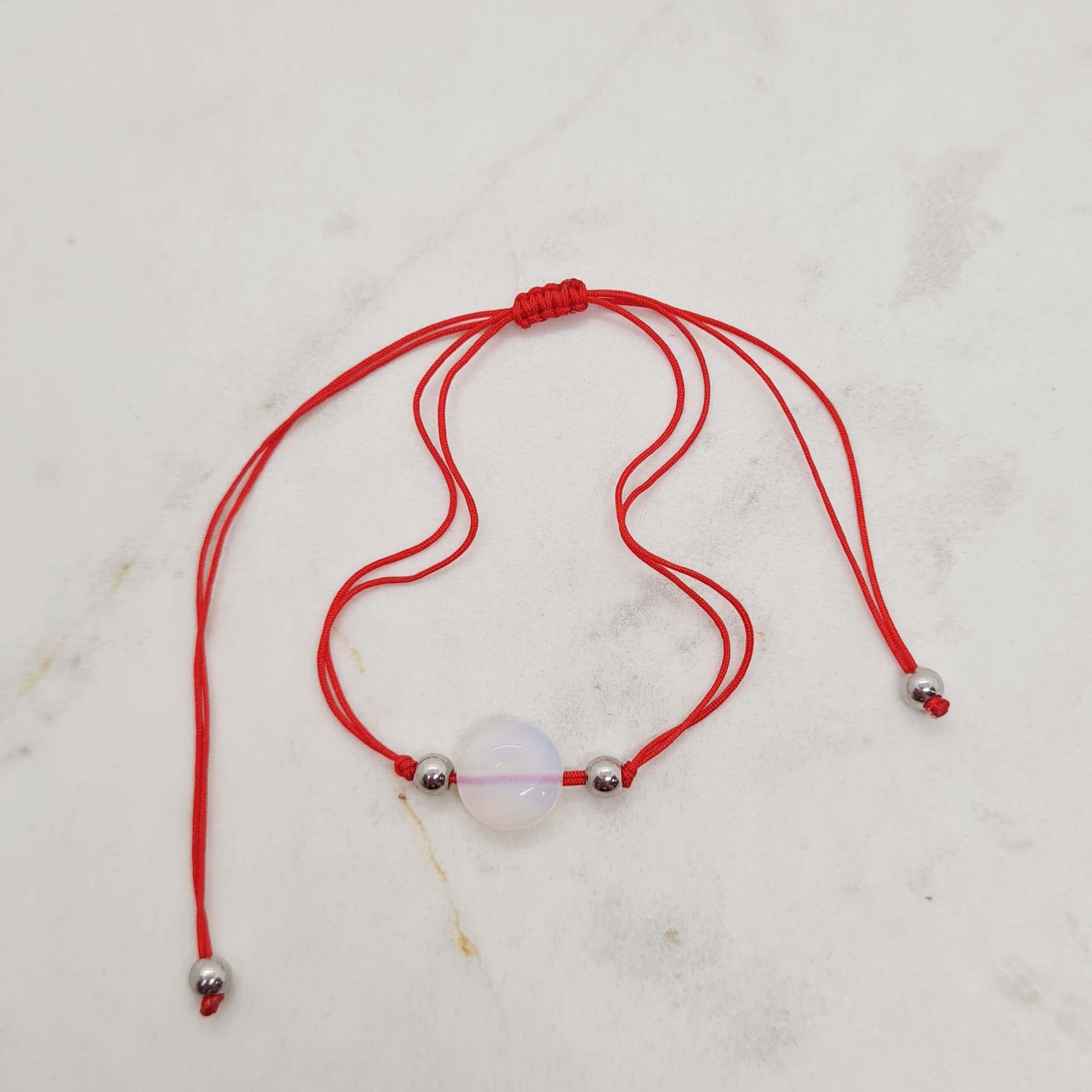 Imagen de producto PULSERA DE HILO ROJO - PIEDRA LUNAR REDONDA