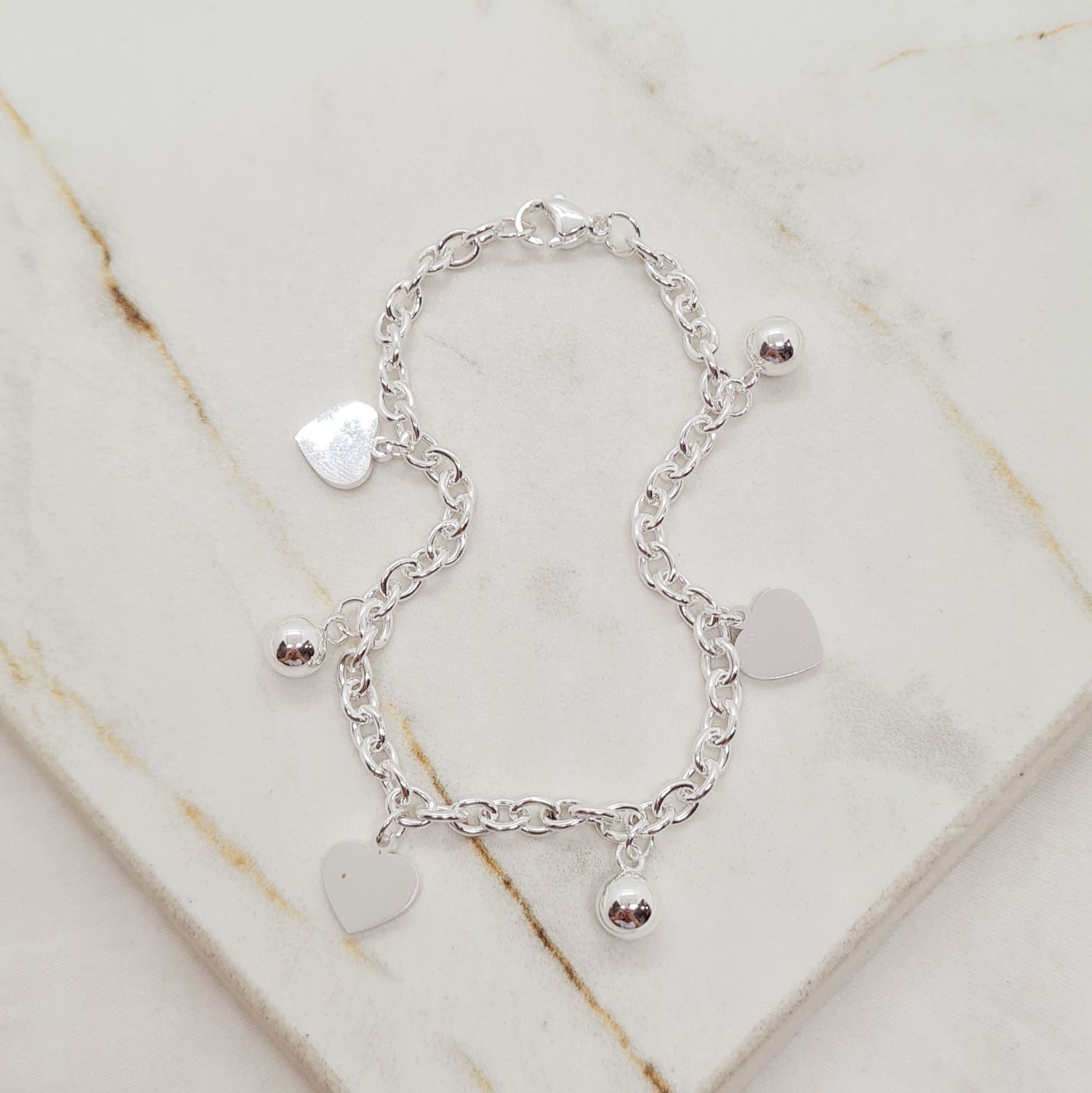 Imagen de producto PULSERA ACERO BLANCO TIFFANY CON BOLITAS Y DIJES - CORAZONES LISOS