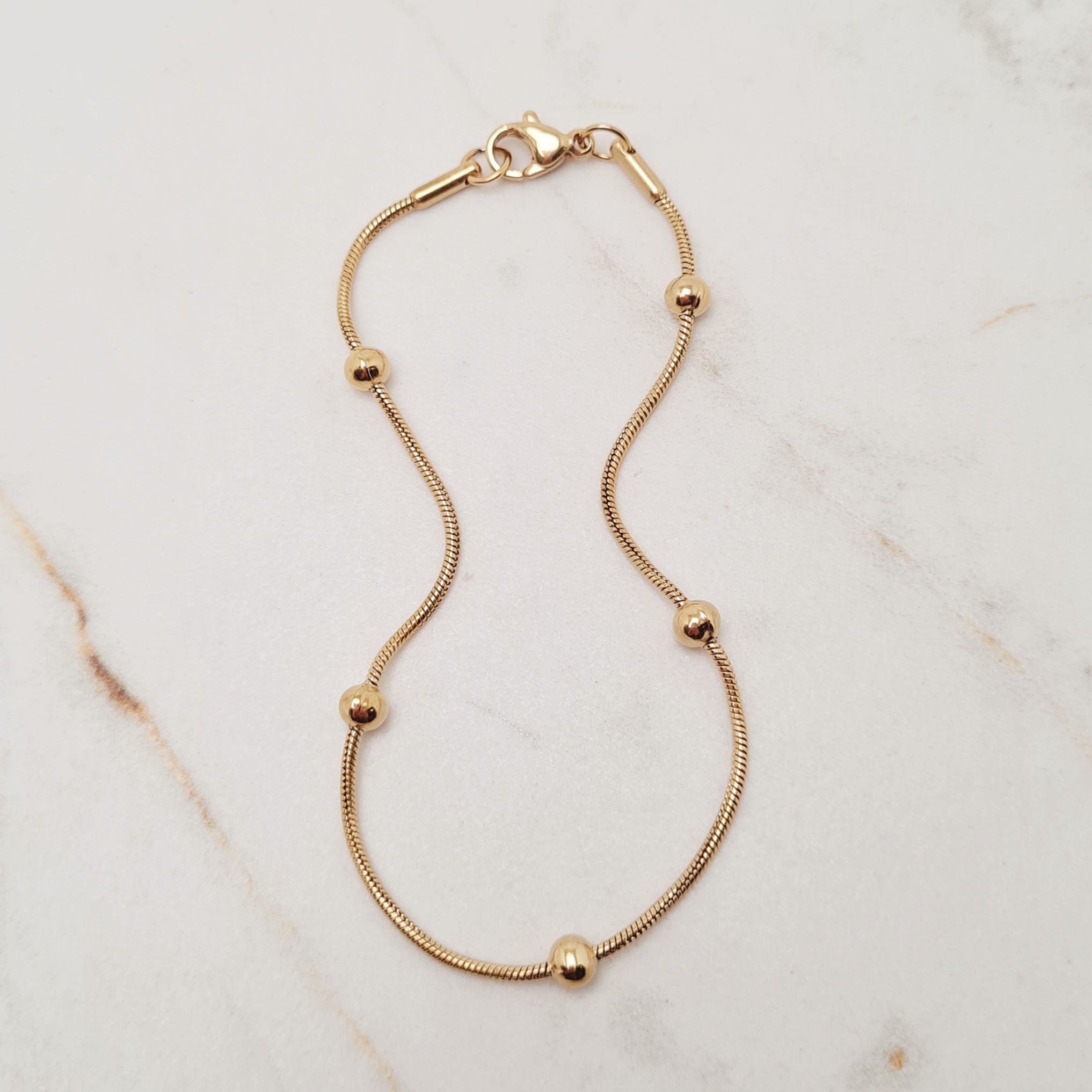 Imagen de producto PULSERA ACERO DORADO COLITA DE RATA CON BOLITAS