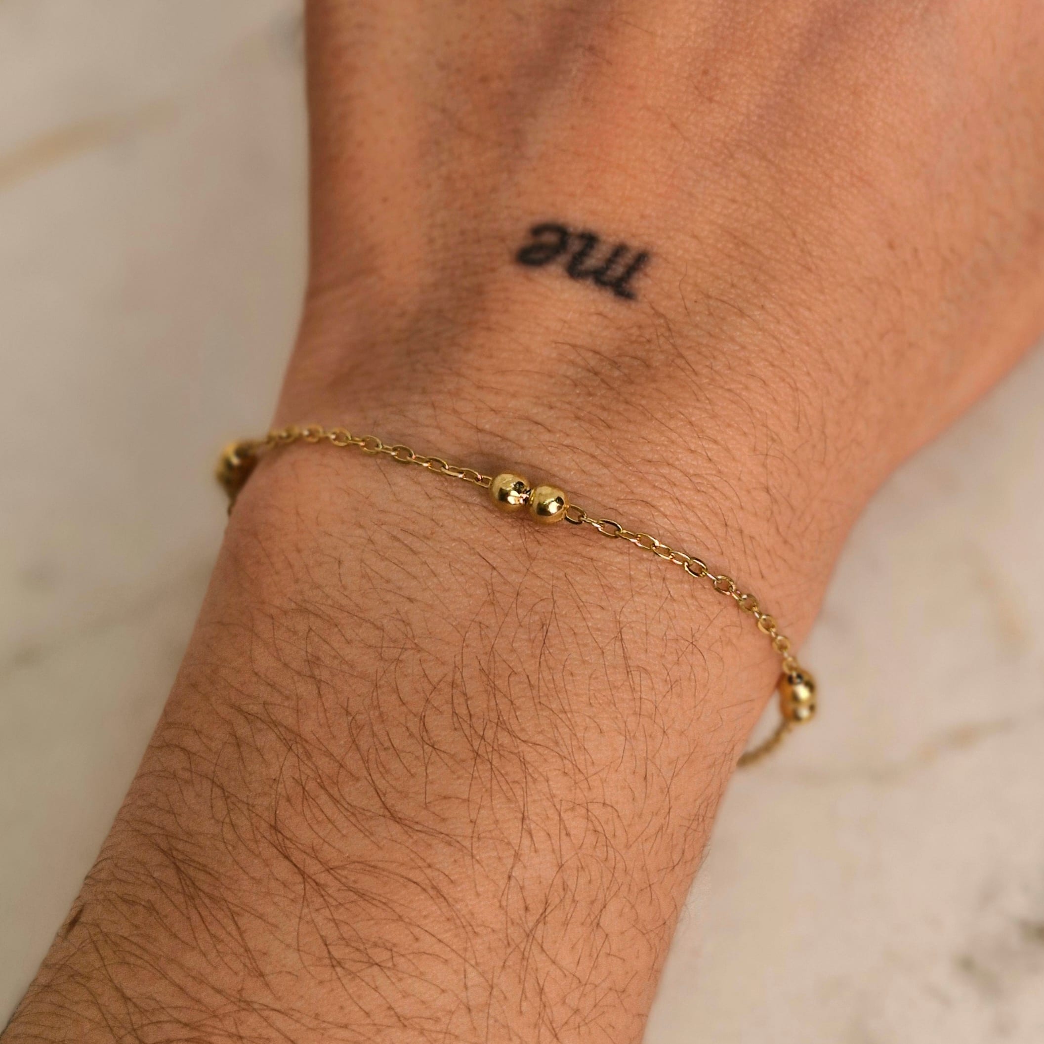 Imagen de producto PULSERA ACERO DORADO FINA CON DOBLE BOLITAS GRANDES