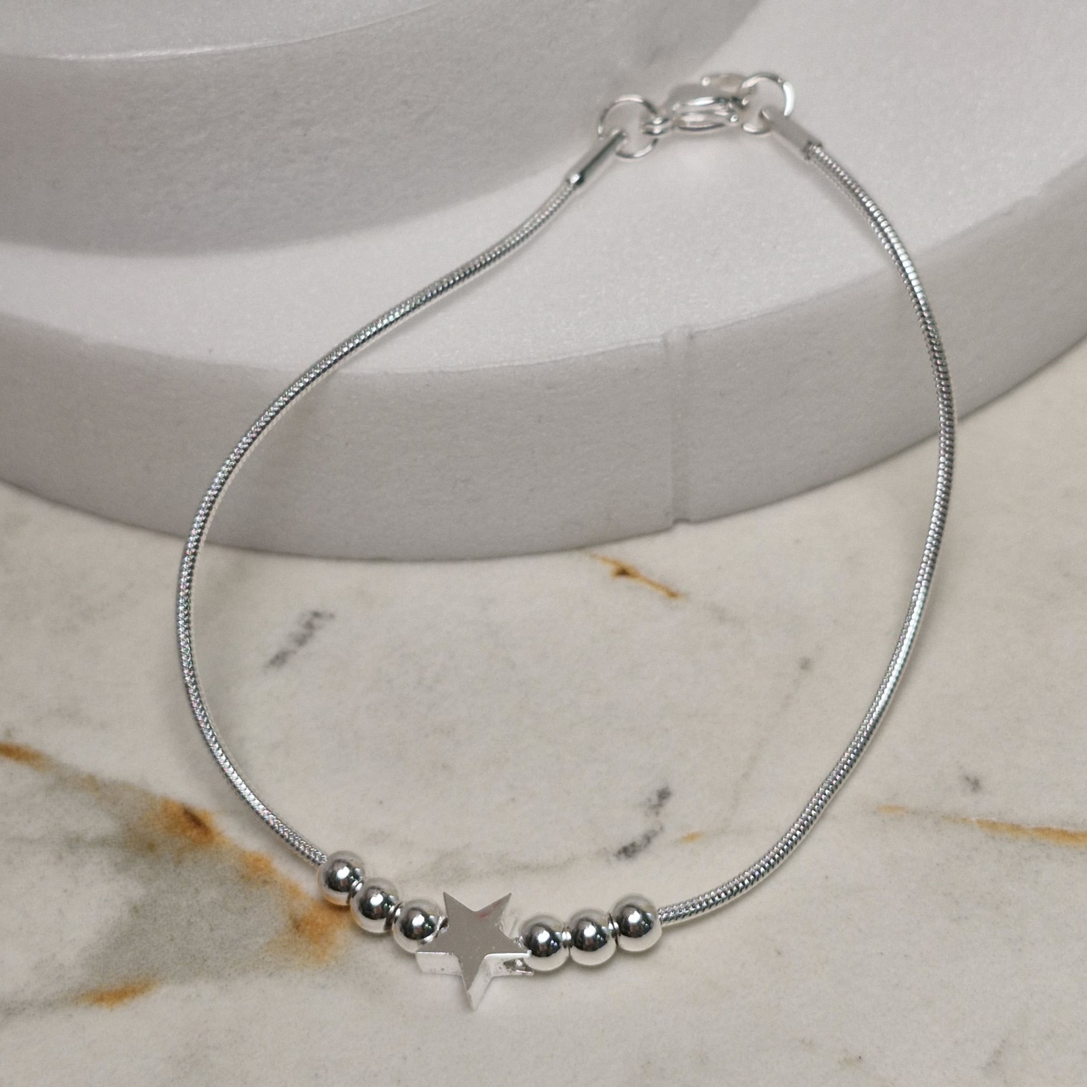 Imagen de producto PULSERA ACERO BLANCO COLITA DE RATA CON BOLITAS Y DIJE - ESTRELLA