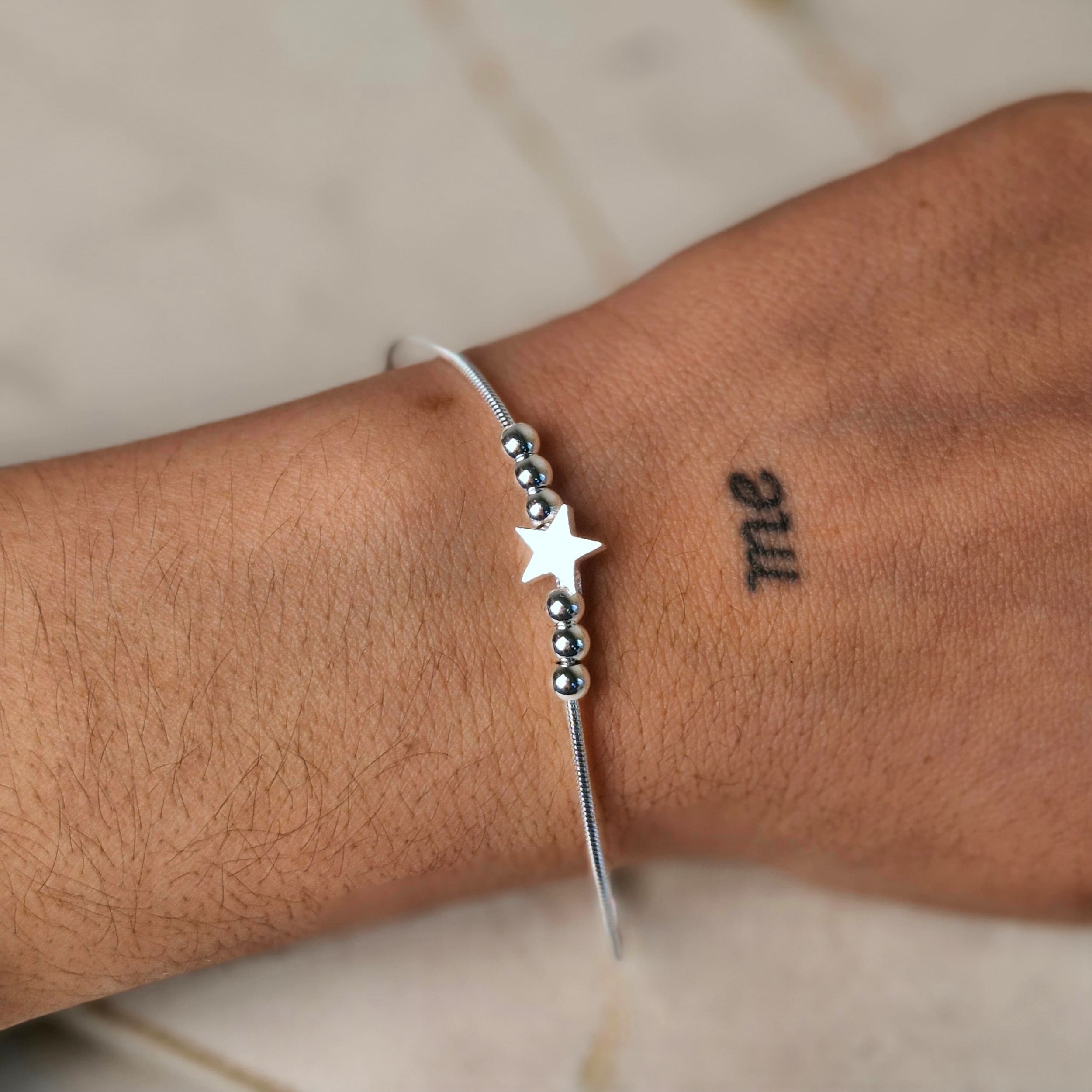 Imagen de producto PULSERA ACERO BLANCO COLITA DE RATA CON BOLITAS Y DIJE - ESTRELLA
