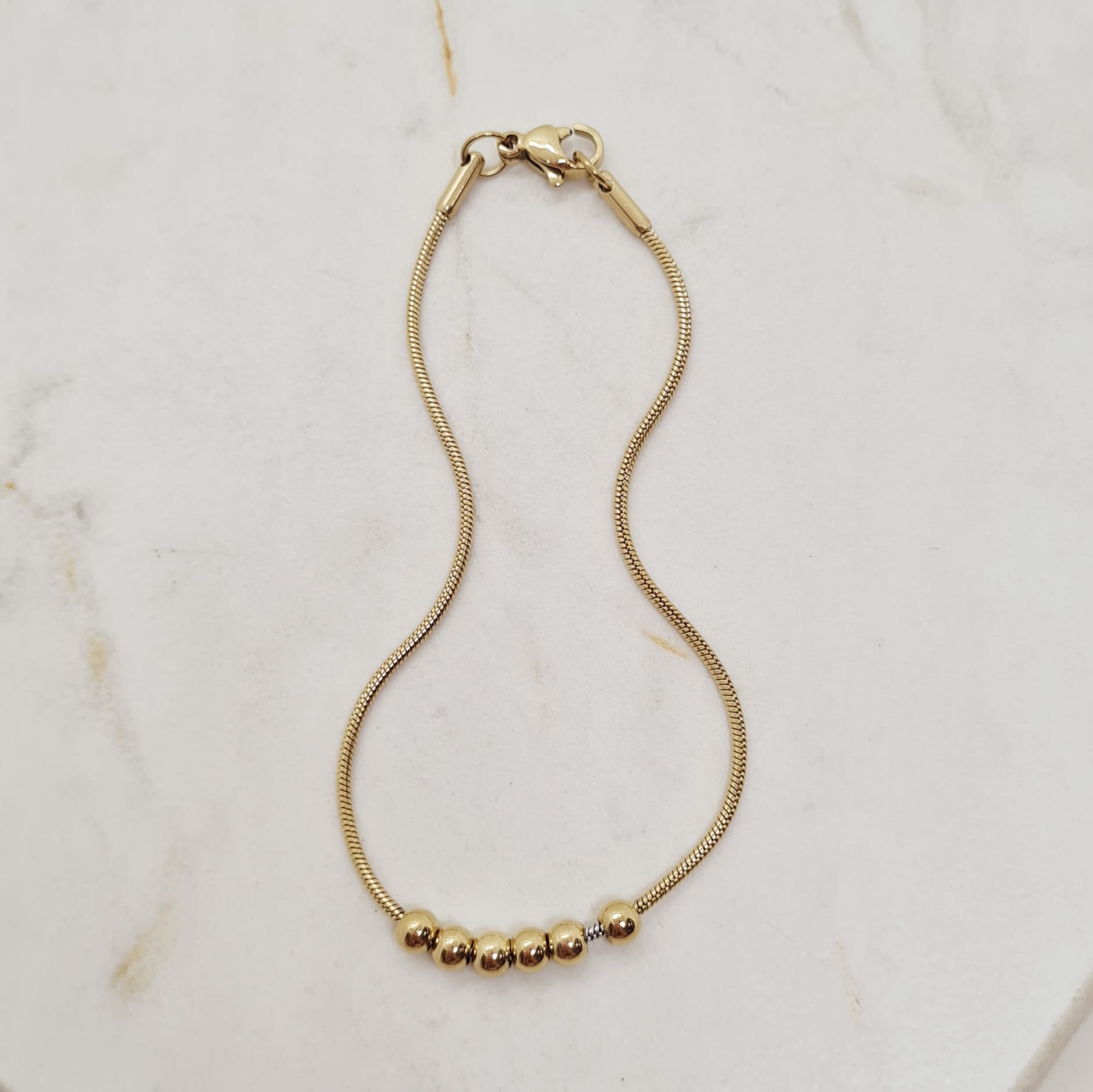 Imagen de producto PULSERA ACERO DORADO COLITA DE RATA CON 6 BOLITAS JUNTAS