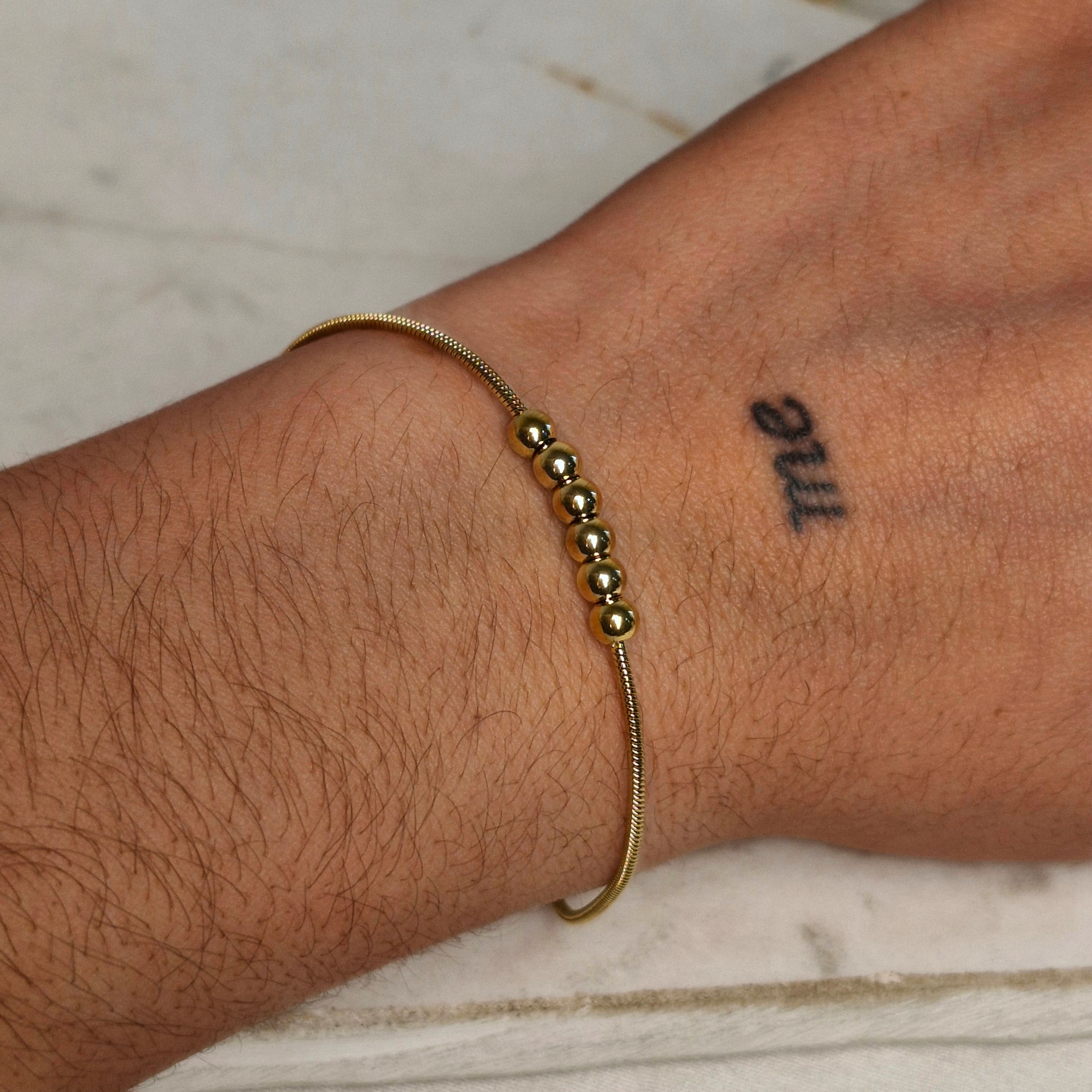 Imagen de producto PULSERA ACERO DORADO COLITA DE RATA CON 6 BOLITAS JUNTAS