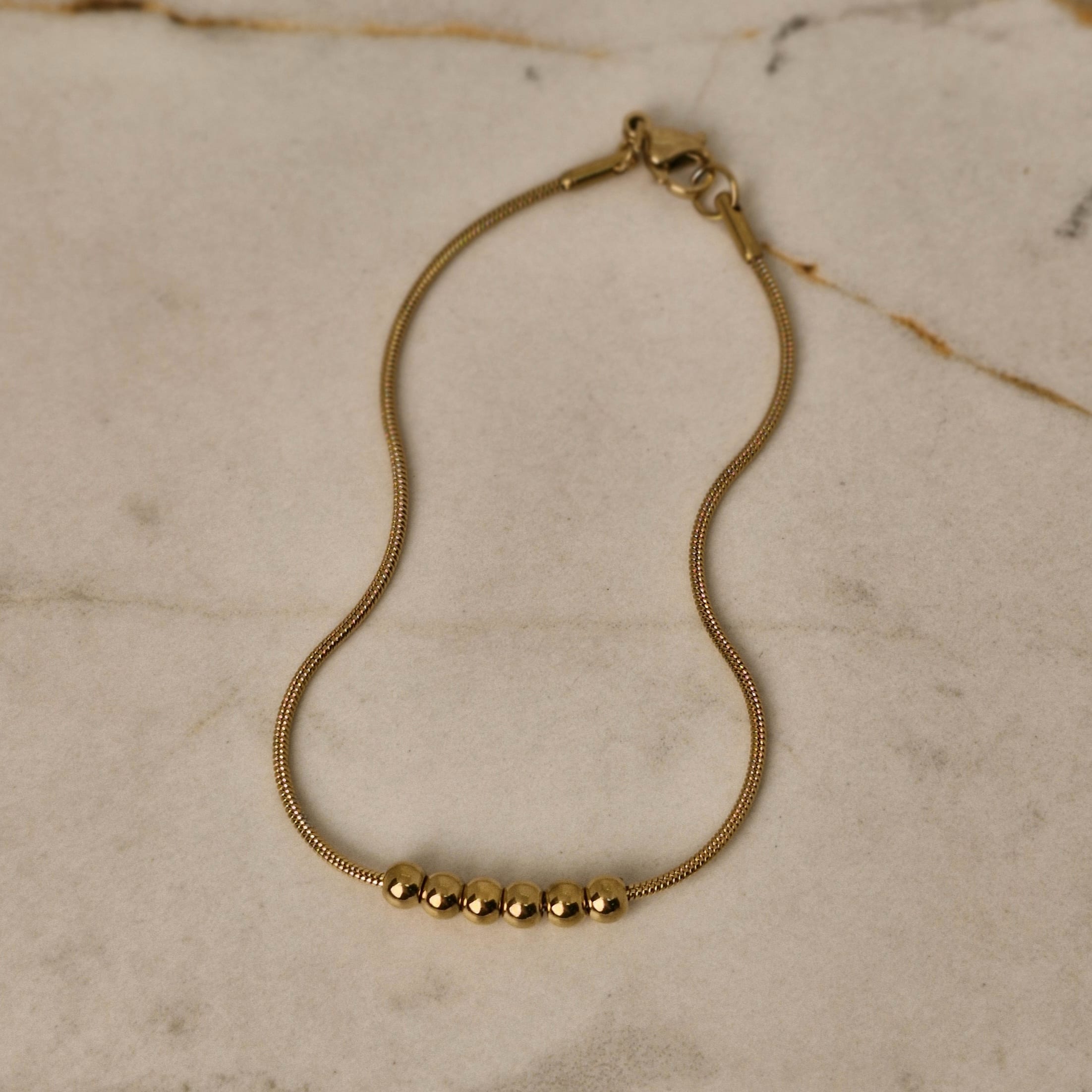 Imagen de producto PULSERA ACERO DORADO COLITA DE RATA CON 6 BOLITAS JUNTAS