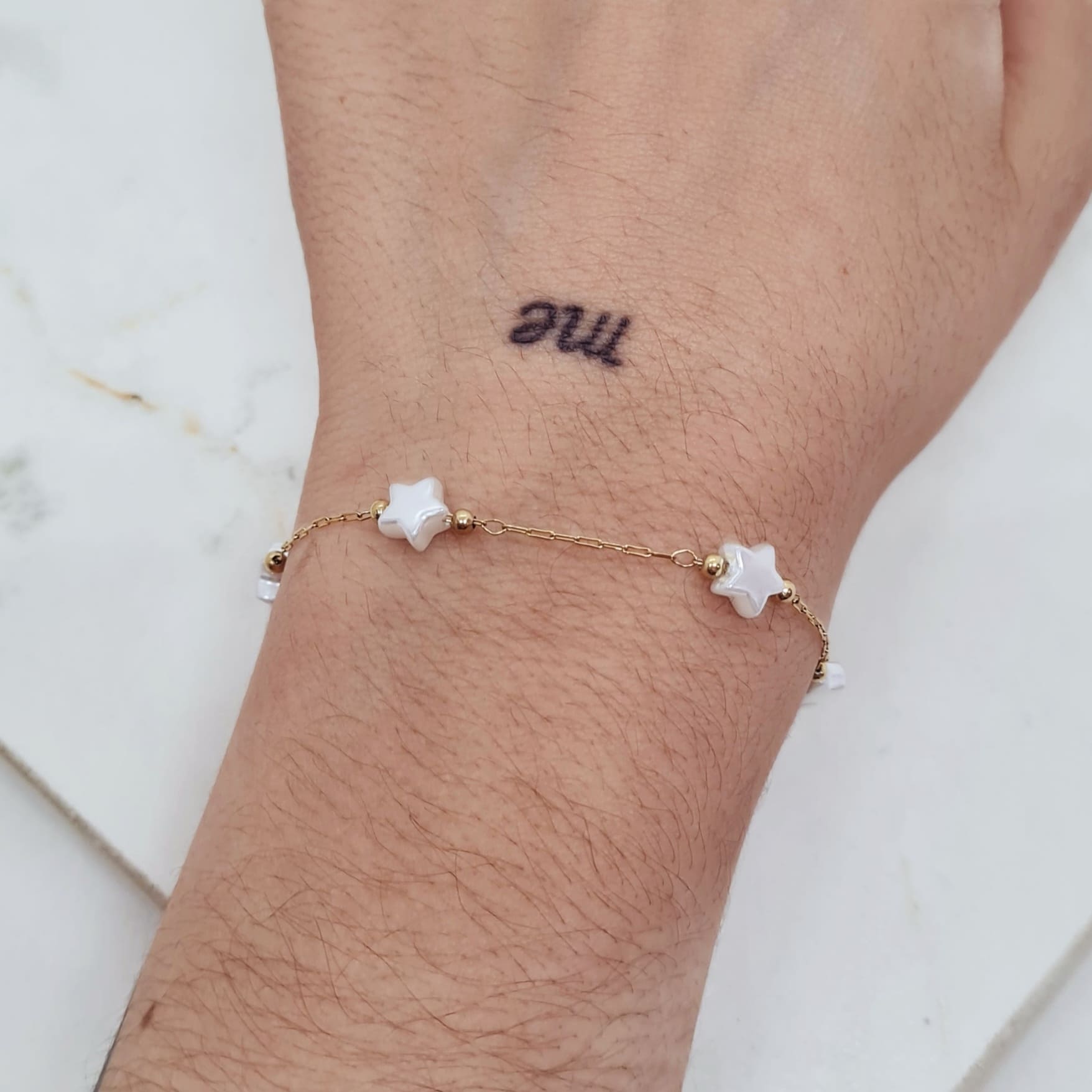 Imagen de producto PULSERA ACERO DORADO FINA CON BOLITAS Y PERLITAS ESTRELLAS