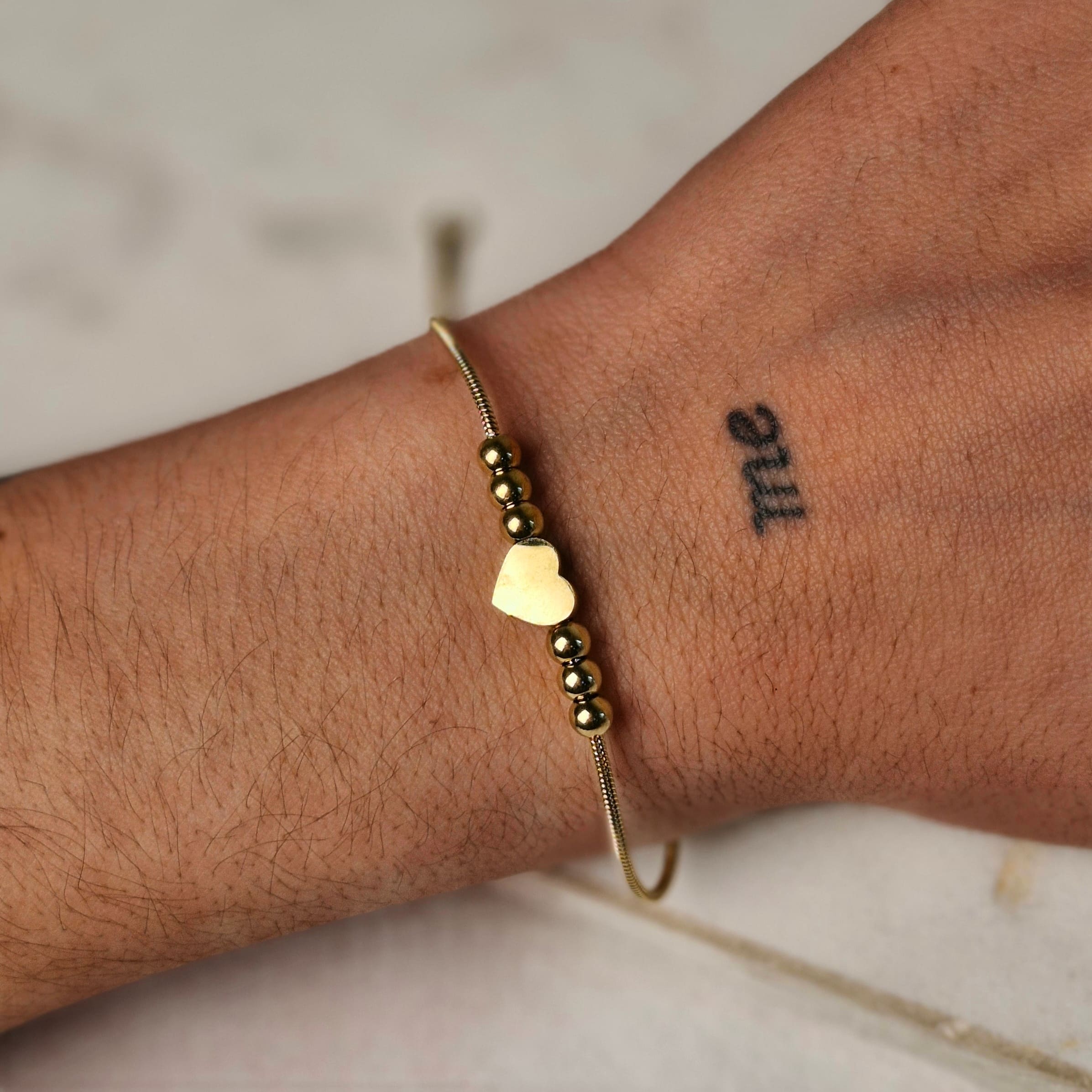 Imagen de producto PULSERA ACERO DORADO COLITA DE RATA CON BOLITAS Y CORAZON
