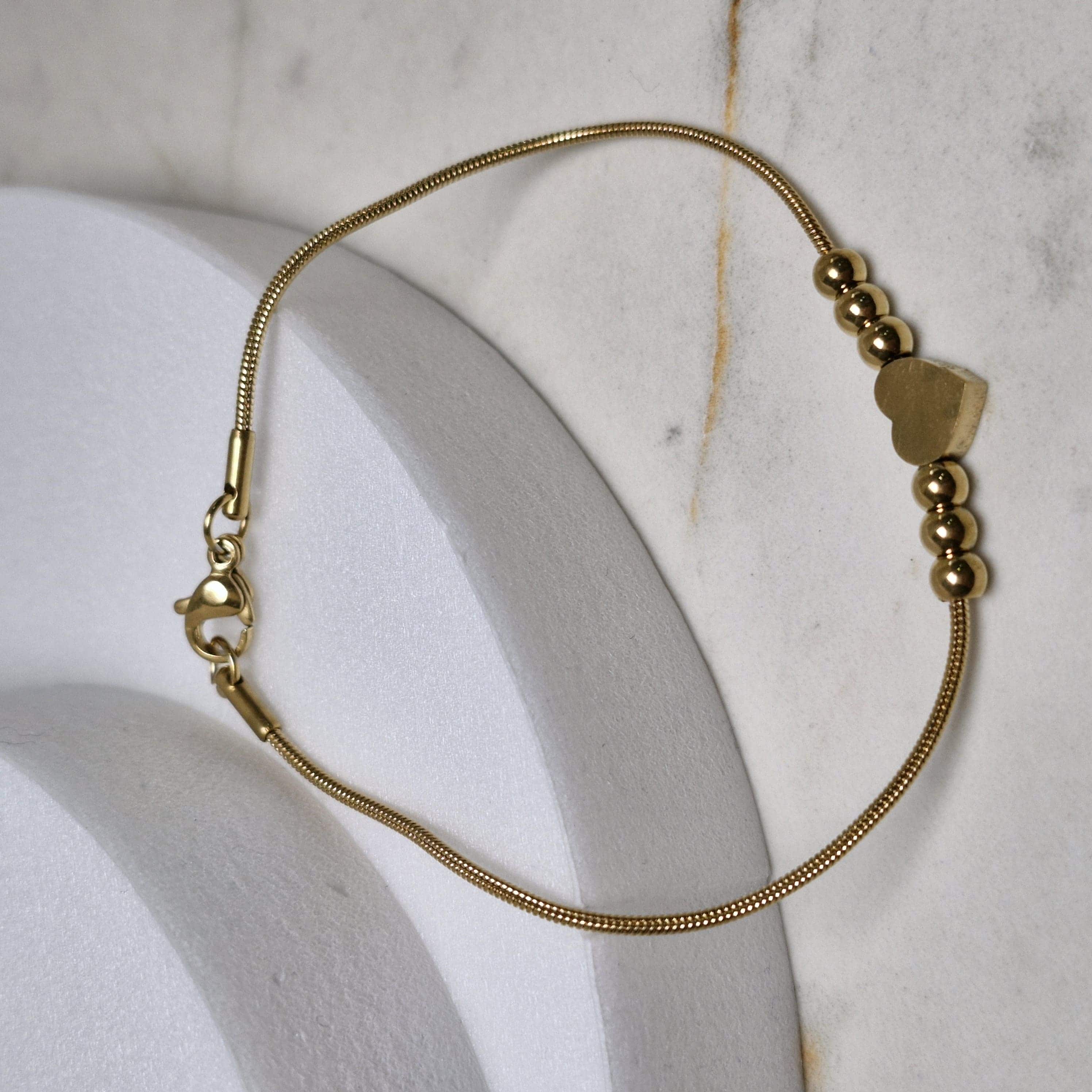 Imagen de producto PULSERA ACERO DORADO COLITA DE RATA CON BOLITAS Y CORAZON
