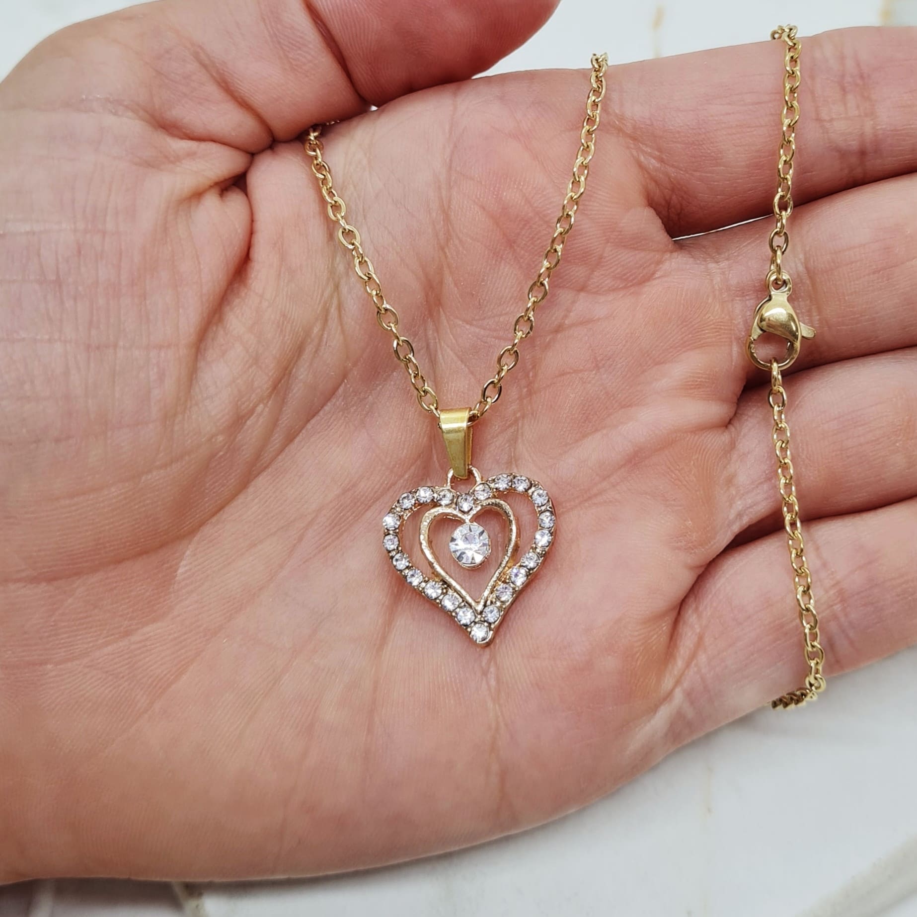 Imagen de producto COLLAR ACERO DORADO - DOBLE CORAZON FULL STRASS Y CUBIC EN EL CENTRO