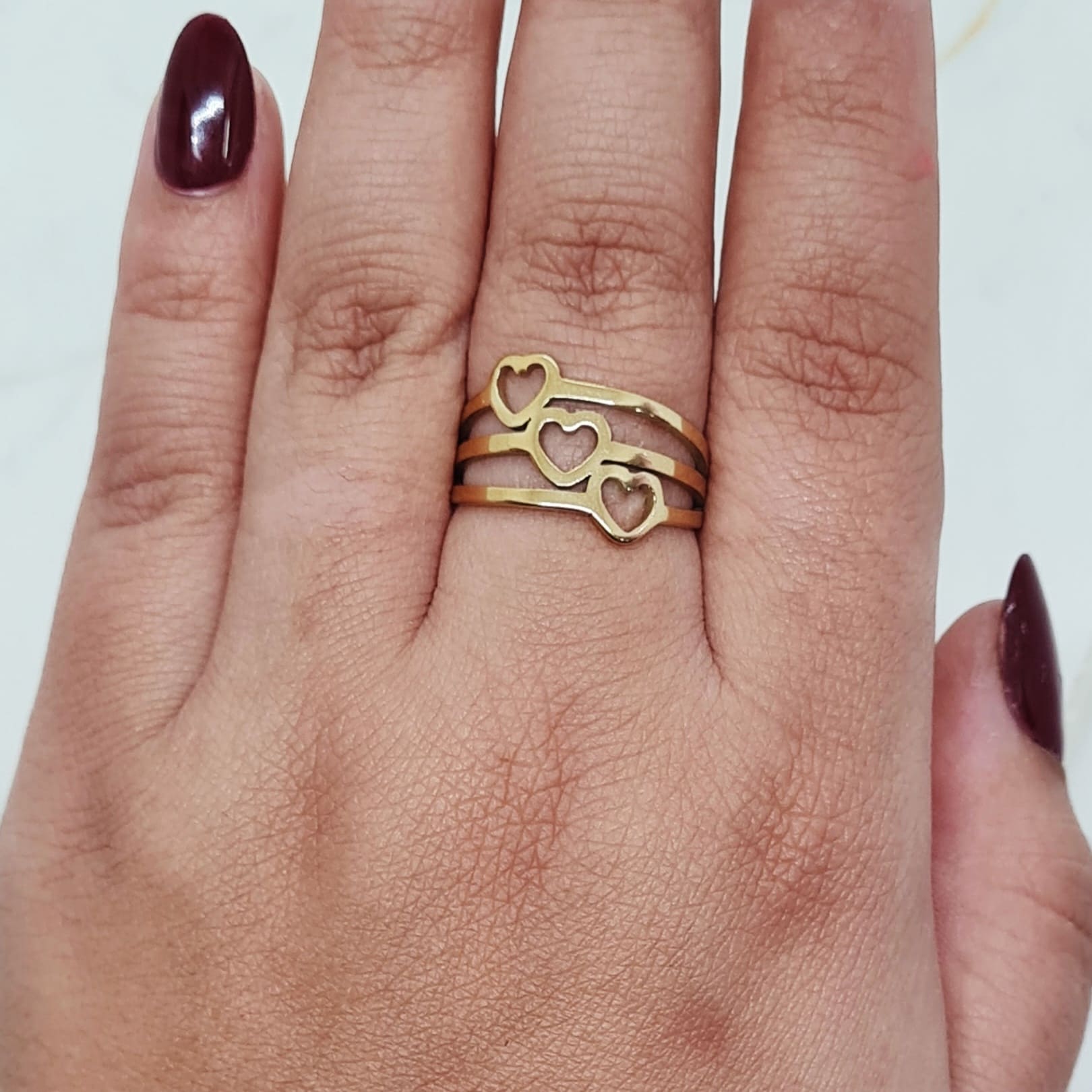 Imagen de producto ANILLO ACERO DORADO - TRIPLE LINEA CORAZONES CALADOS